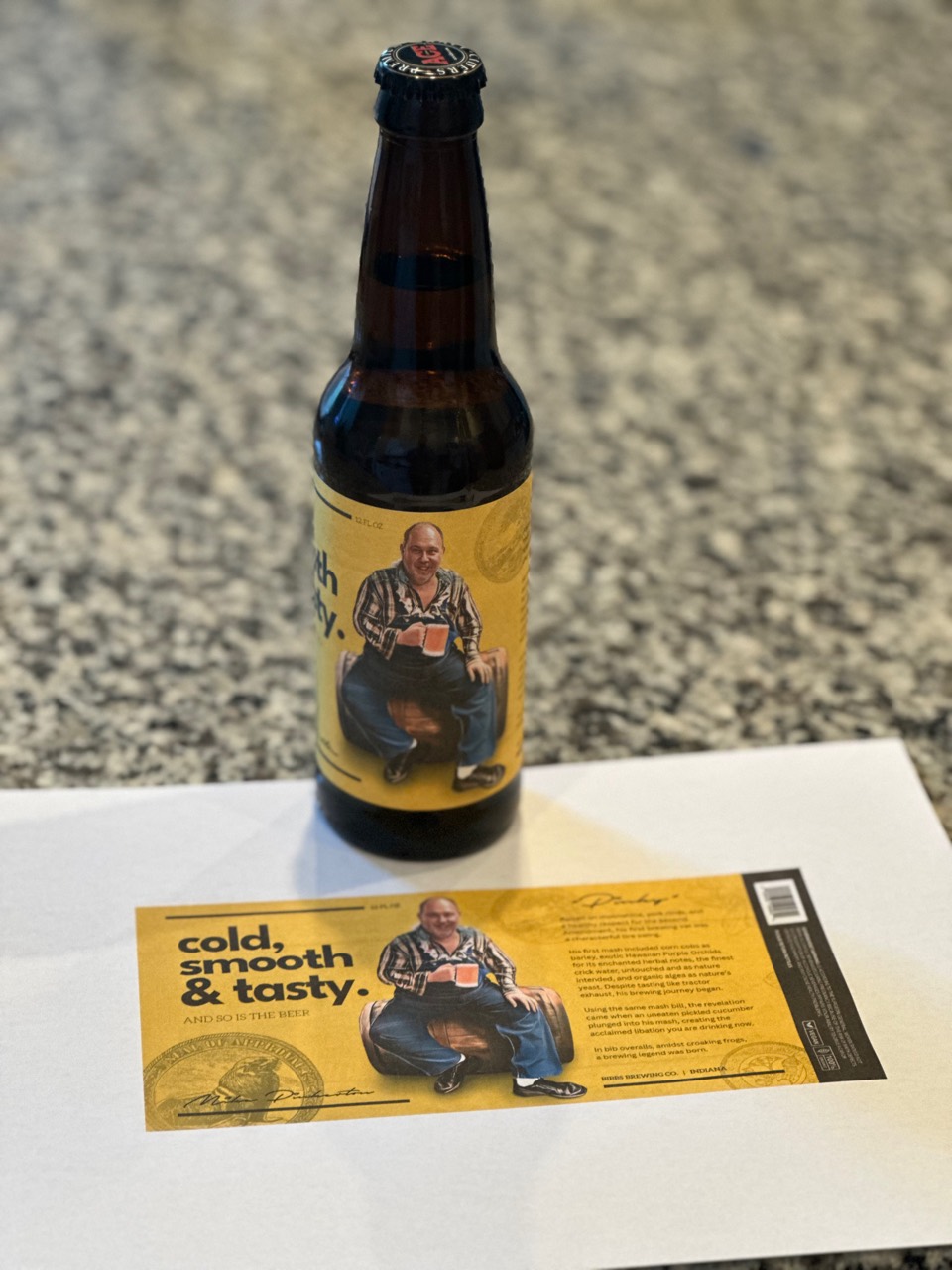 A bottle mockup alongside the complete yellow printed label.